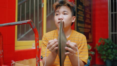 Kamerafahrt-Eines-Jungen,-Der-In-Jakarta-Ein-Instrument-Spielt