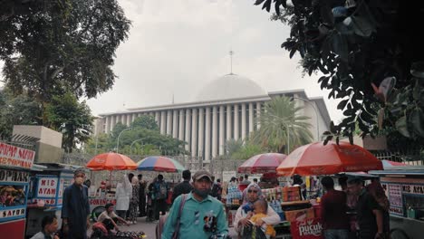 Tracking-Shot-of-Food-Stalls-and-Istiqlal-Mosque
