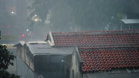 Long-Shot-of-Rain-Pouring-Onto-Rooftops