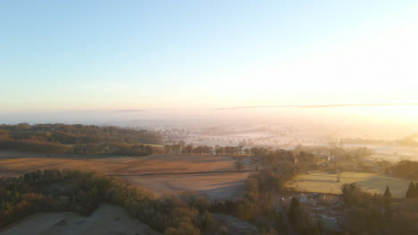 Drone-Shot-of-Vast-Misty-Rural-Landscape-at-Sunrise