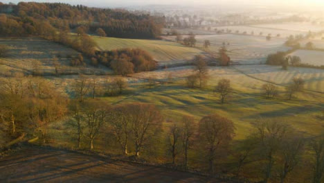 Drone-Shot-of-Panning-Up-Over-Misty-Rural-Landscape-at-Sunrise