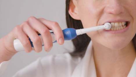 Close-Up-Shot-of-a-Woman-Brushing-Her-Teeth