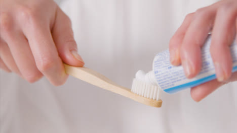 Close-Up-Shot-of-Woman-Applying-Toothpaste-to-Brush