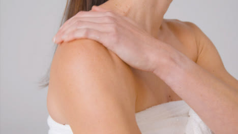 Close-Up-Shot-of-a-Woman-Applying-Cream-to-Arms