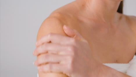 Close-Up-Shot-of-a-Lady-Applying-Cream-to-Arms
