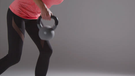 Mid-Shot-of-Woman-Lifting-Weights-at-Gym