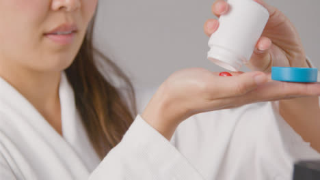 Mid-Shot-of-a-Young-Woman-Taking-Tablets