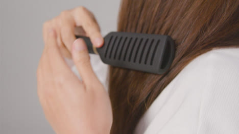 Close-Up-Shot-of-Hair-Being-Brushed