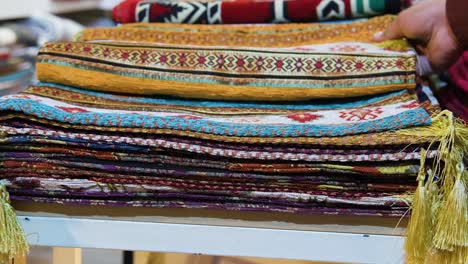 Close-Up-Shot-of-Man-Looking-At-Rugs