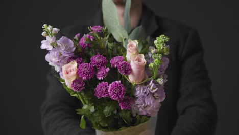 Mid-Shot-of-Man-Holding-Flowers