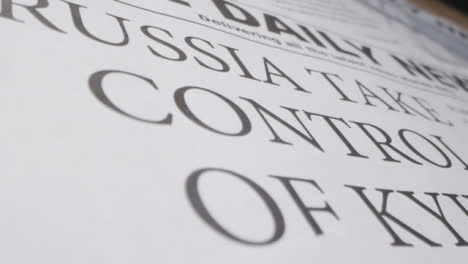 Tracking-Close-Up-Newspaper-Headline-Russia-Takes-Control