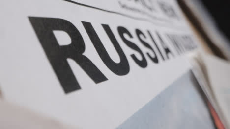Slow-Tracking-Close-Up-Newspaper-Headline-Russia-Invades