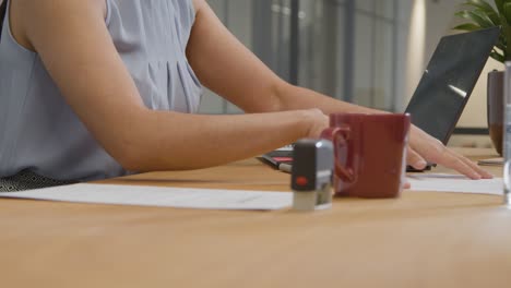 Mid-Shot-of-Woman-Stamping-Paper