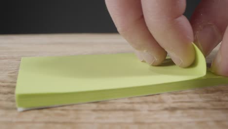Close-Up-of-Someone-Taking-Sticky-Note