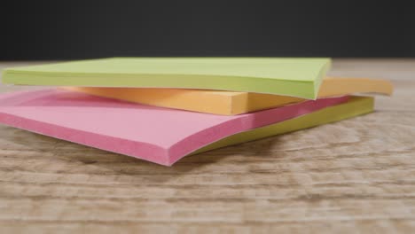 Close-Up-of-Someone-Picking-Up-Sticky-Notes