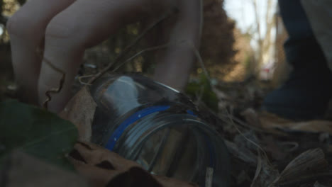 Low-Angle-Shot-Of-Someone-Picking-Up-Rubbish-