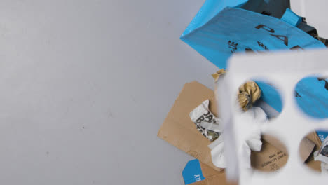 Top-Down-Shot-of-Mixed-Papers-Being-Thrown-into-Bag-with-Copy-Space