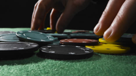 Close-Up-of-Someone-Putting-Tokens-into-Piles