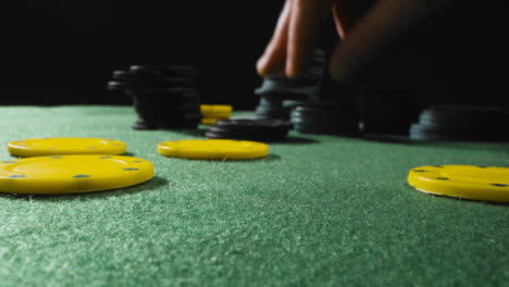 Close-Up-Of-Someone-Putting-Tokens-into-Piles