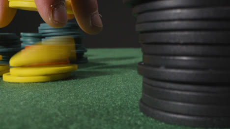 Close-Up-Of-Someone-Putting-Tokens-Into-Piles
