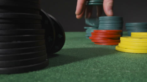 Close-Up-of-Person-Putting-Tokens-into-Piles