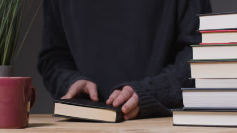 Mid-Shot-of-Man-Reading-with-Hot-Drink