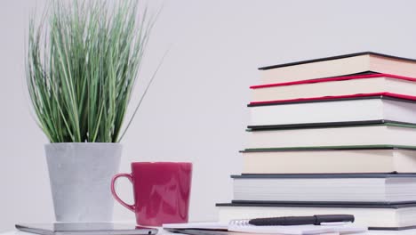 Stop-Motion-Shot-of-Pile-of-Books-On-Desk