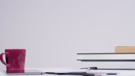 Stop-Motion-Shot-of-Pile-of-Books-On-a-Desk