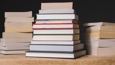 Stop-Motion-Shot-of-Pile-of-Books-On-Table