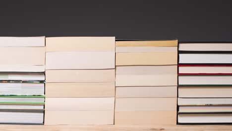 Stop-Motion-Shot-of-Stacks-of-Books-On-a-Table