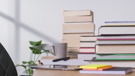 Stop-Motion-Shot-of-Stacks-of-Books-and-Notebook-On-Desk
