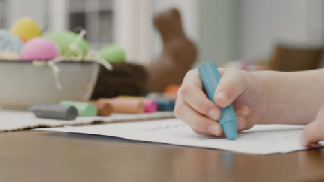 Pull-Focus-Shot-of-a-Young-Child-Colouring-Easter-Themed-Drawings