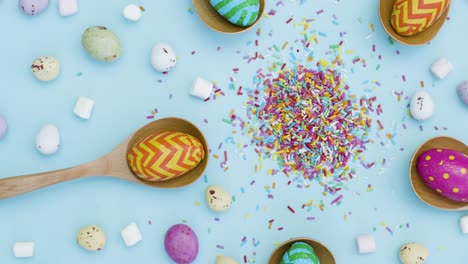 Tracking-Shot-of-Easter-Eggs-In-Wooden-Spoons-with-Mixed-Confectionary