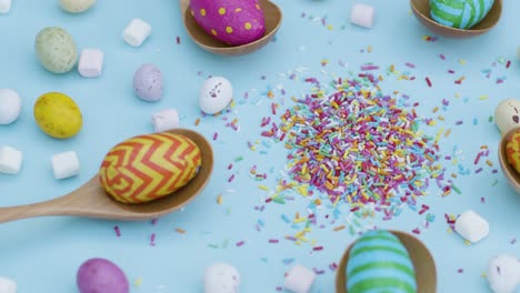 High-Angle-Shot-of-Rotating-Easter-Eggs-In-Wooden-Spoons-with-Confectionary