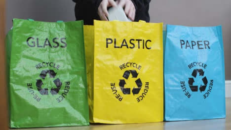 Medium-Shot-of-Person-Placing-Rubbish-into-Recycling-Bags-