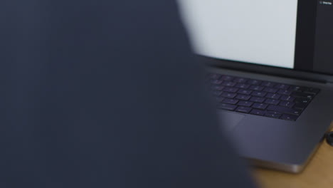 Over-the-Shoulder-Shot-of-Person-Typing-On-New-Apple-MacBook-Pro-01