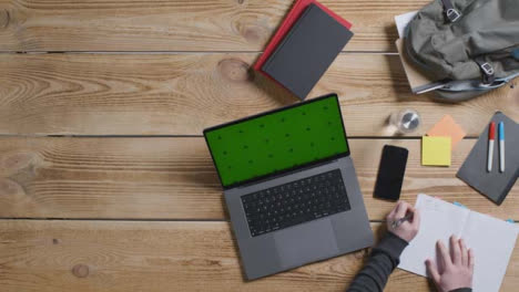 Top-Down-Shot-of-Person-Working-at-Desk-with-Green-Screen-Apple-MacBook-Pro-07