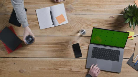 Top-Down-Shot-of-Two-People-Working-at-a-Desk-