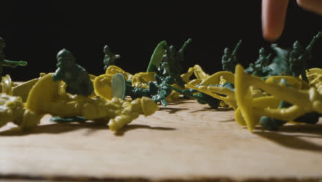Tracking-Shot-of-Multiple-Toy-Soldiers-Being-Knocked-Down