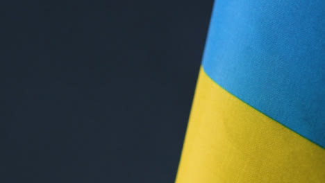Tracking-Shot-of-Ukrainian-Flag-Admist-Haze-and-Flashing-Lights