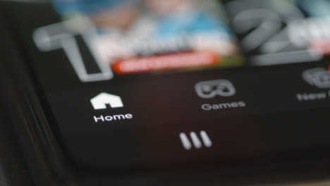 Close-Up-Tracking-Shot-of-Netflix-Menu-Icons-on-Phone