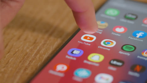 Tracking-shot-of-Opening-YouTube-on-Phone-with-Copyspace