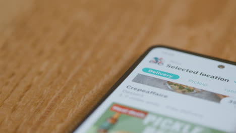 Close-Up-of-Browsing-Deliveroo-on-Phone-with-Copyspace