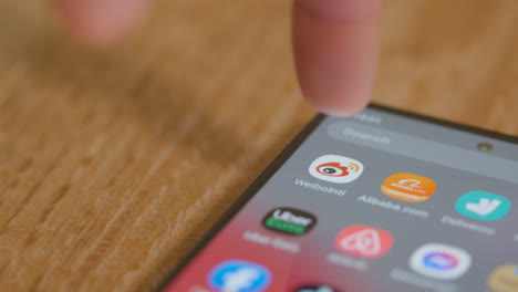 Tracking-Shot-of-Opening-Weibo-on-Phone-with-Copyspace