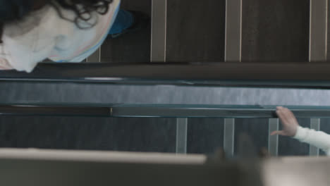 Top-Down-Shot-of-Students-Walking-In-Stairwell