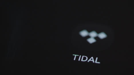 Close-Up-Shot-of-a-Finger-Tapping-Tidal-On-Smartphone-Screen