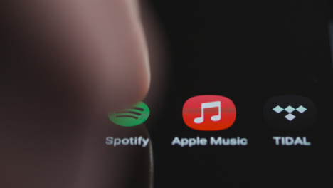 Nahaufnahme-Von-Fingertippen-Auf-Spotify-Musik-Auf-Einem-Smartphone-Touchscreen