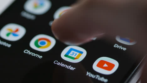 Close-Up-Shot-of-a-Finger-Tapping-Google-Calendar-App-On-a-Smartphone