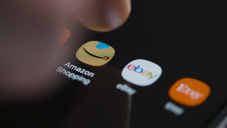 Close-Up-Shot-of-Finger-Tapping-the-Amazon-Shopping-App-On-Smartphone