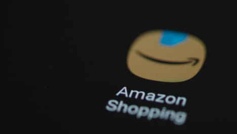 Close-Up-Shot-of-Finger-Tapping-the-Amazon-Shopping-App-On-a-Smartphone-Screen